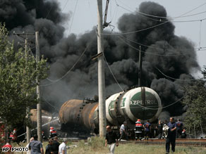 Firefighters extinguish a blaze on a train carrying oil products east of the Georgian city of Gori on Sunday.
