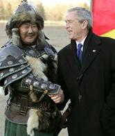 President George W. Bush shakes hands with a Mongolian cultural performer.