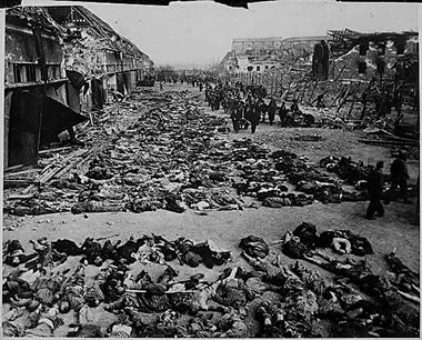 Image:Rows of bodies of dead inmates fill the yard of Lager Nordhausen, a Gestapo concentration camp.jpg