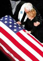 The Rev. Michael Wenning comforts Nancy Reagan at the coffin of former President Ronald Reagan.