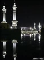 The Grand Mosque in Mecca, illuminated at night and reflected on a marble surface
