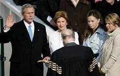 President George Bush takes the oath on stage with his twin daughters Jenna (R) and Barbara (2nd-R) and by his wife US First Lady Laura Bush.