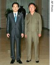In this photo released from the South Korean Unification Ministry, South Korean Unification Minister Chung Dong-young, left, poses with North Korean leader Kim Jong Il, Friday